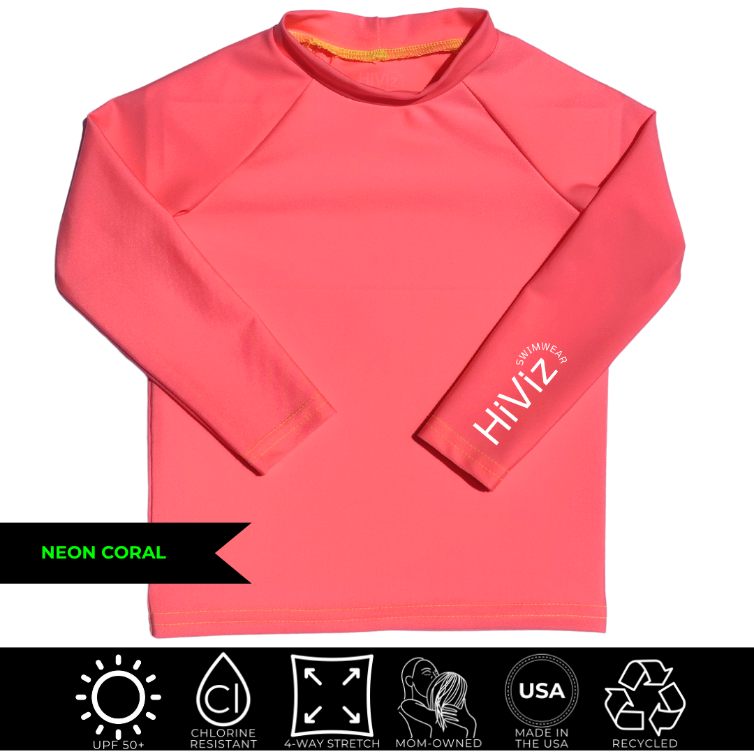 Bright swimwear for toddlers, this is a product image of a toddler neon coral rash guard with HiViz bright swimwear logo on the left sleeve.